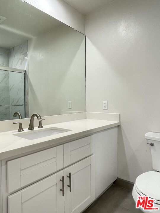 11738 Mayfield Avenue, Unit 114 Los Angeles, CA 90049 - Photo 22 of 25 a bathroom with a sink and a toilet
