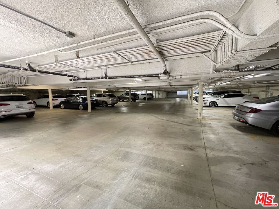 11738 Mayfield Avenue, Unit 114 Los Angeles, CA 90049 - Photo 24 of 25 a view of a garage with cars