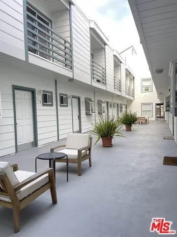 a backyard of a house with outdoor seating