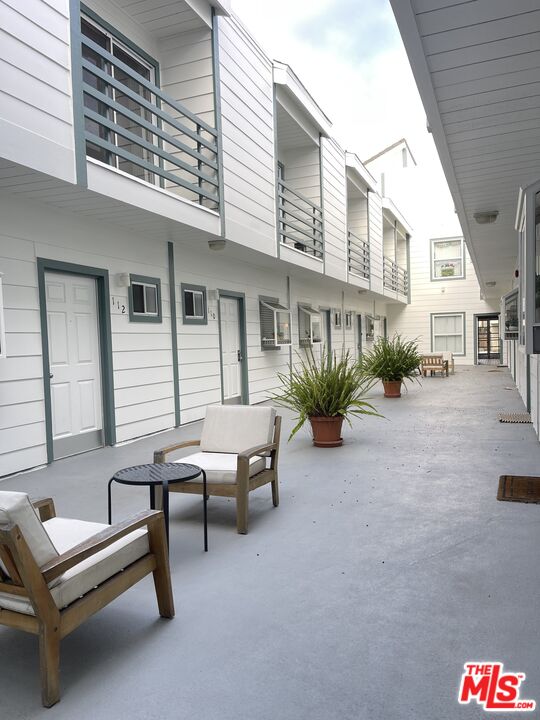 11738 Mayfield Avenue, Unit 114 Los Angeles, CA 90049 - Photo 3 of 25 a backyard of a house with outdoor seating