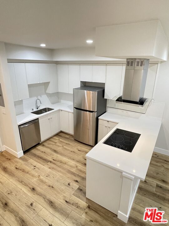 11738 Mayfield Avenue, Unit 114 Los Angeles, CA 90049 - Photo 6 of 25 a kitchen with a refrigerator sink and stove