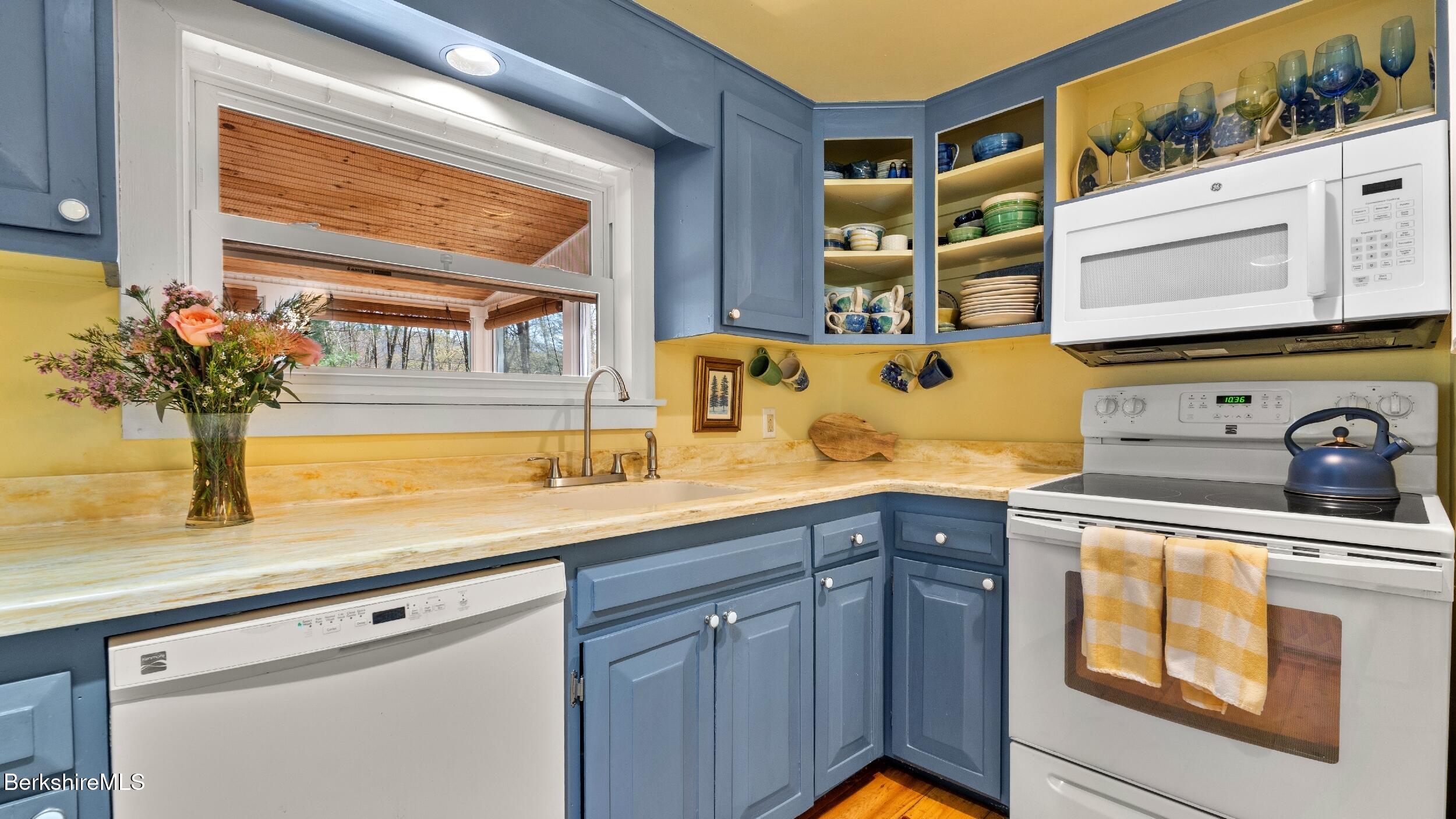 7 Lake Buel Road Great Barrington, MA 01230 - Photo 13 of 42 a kitchen with a sink and a stove next to a window