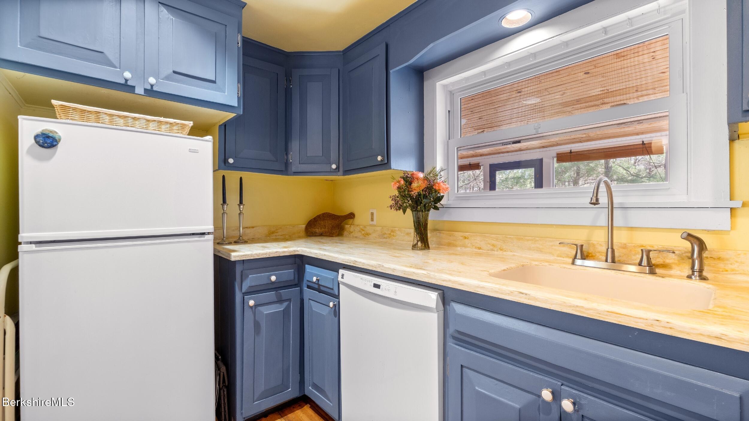 7 Lake Buel Road Great Barrington, MA 01230 - Photo 14 of 42 a kitchen with a sink a refrigerator and cabinets