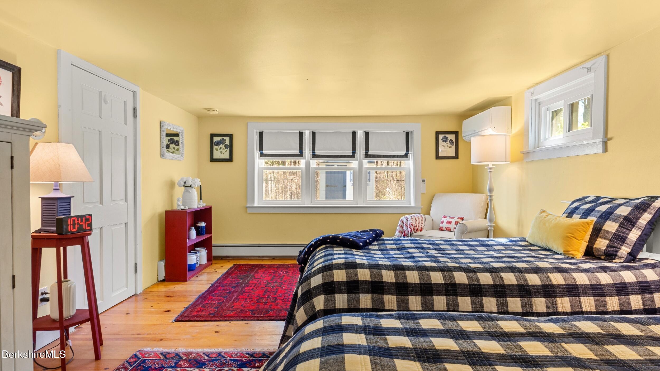 7 Lake Buel Road Great Barrington, MA 01230 - Photo 26 of 42 a bedroom with a bed and wooden floor