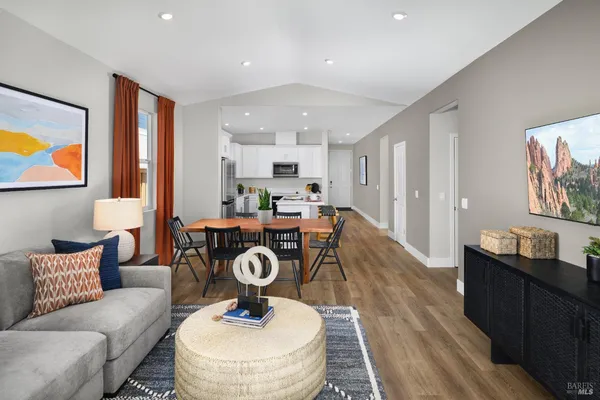a living room with kitchen furniture and a table