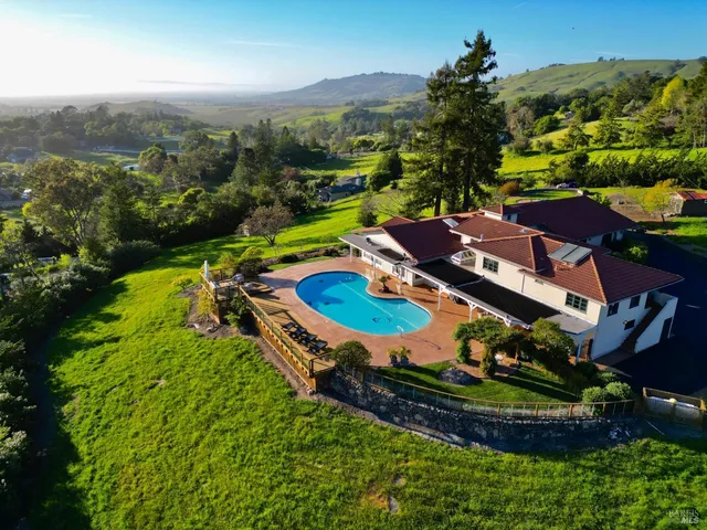 an aerial view of a house with a garden