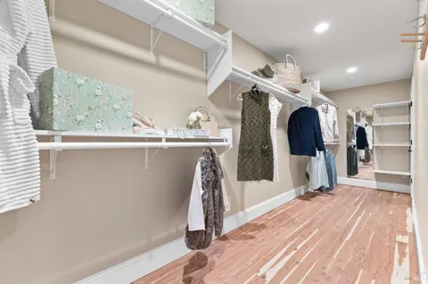 a bedroom with a bed a couch and dresser