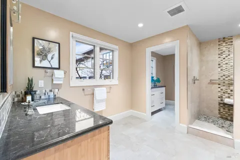 a bathroom with a double vanity sink and a mirror