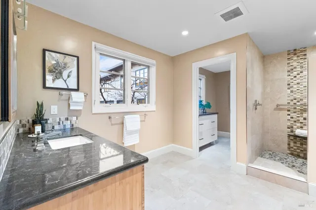 a bathroom with a double vanity sink and a mirror