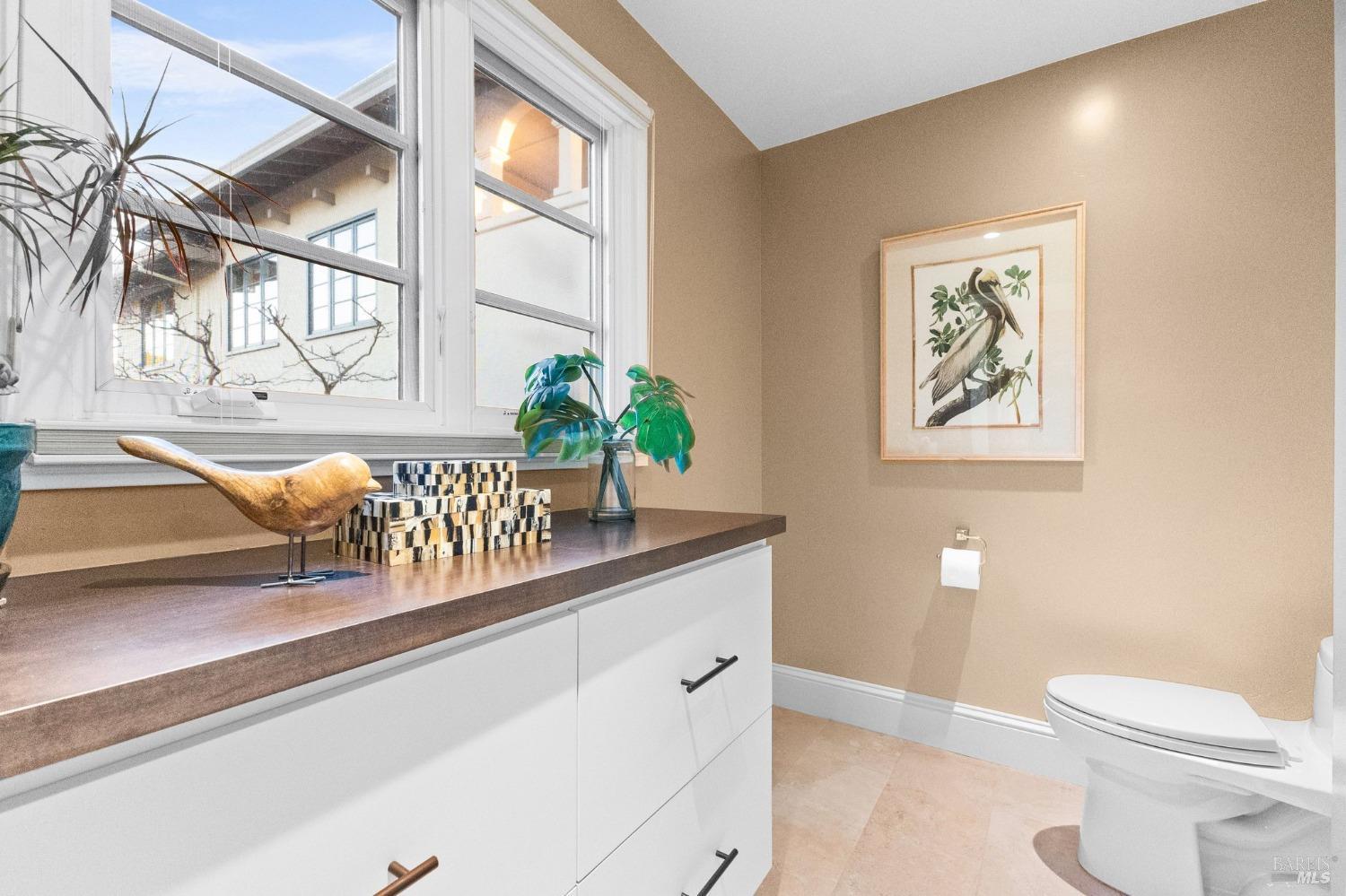 4680 Acacia Lane Penngrove, CA 94951 - Photo 32 of 83 a bath room with a toilet a sink and a large mirror