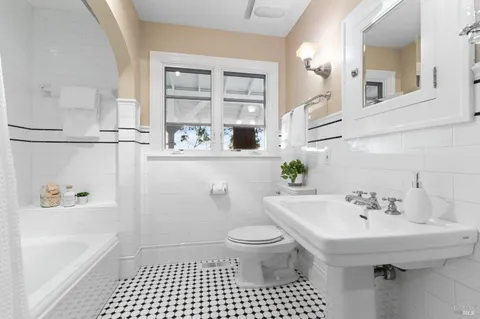 a dining room with furniture and a large window