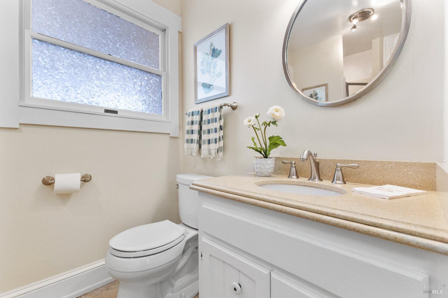 4680 Acacia Lane Penngrove, CA 94951 - Photo 45 of 83 a bathroom with a granite countertop toilet sink and mirror
