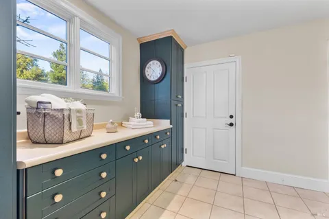 a view of a patio with table and chairs with wooden floor and plants