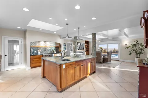 a view of a patio with couches table and chairs with wooden floor and fence