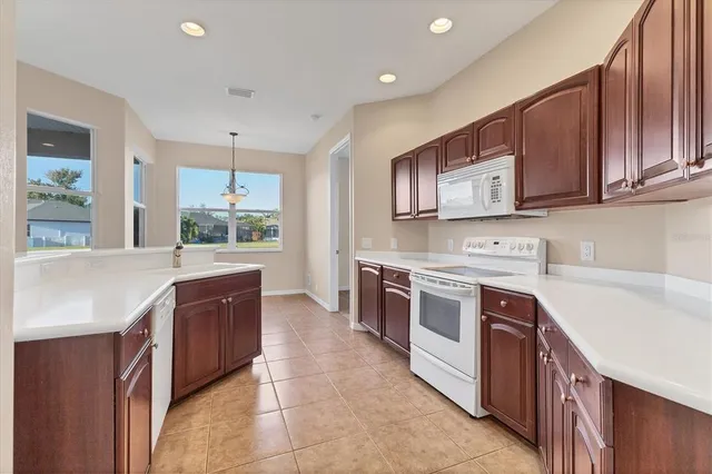 a large kitchen with stainless steel appliances granite countertop a stove and a sink