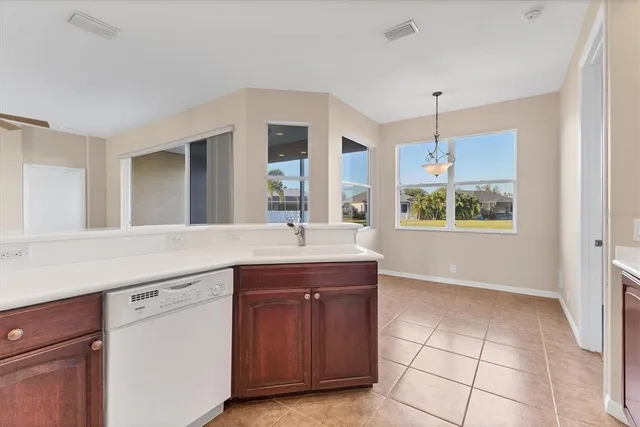 a kitchen with a sink cabinets and window