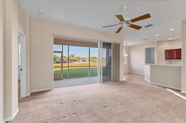 a view of a livingroom with a ceiling fan and window