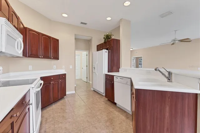 a kitchen with a sink stove and refrigerator
