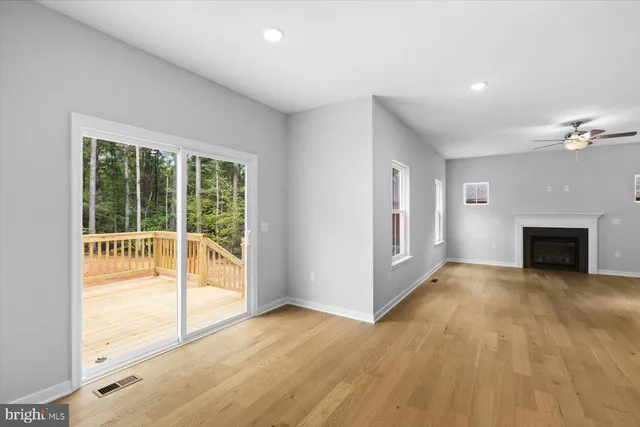 a view of an empty room with glass door and balcony