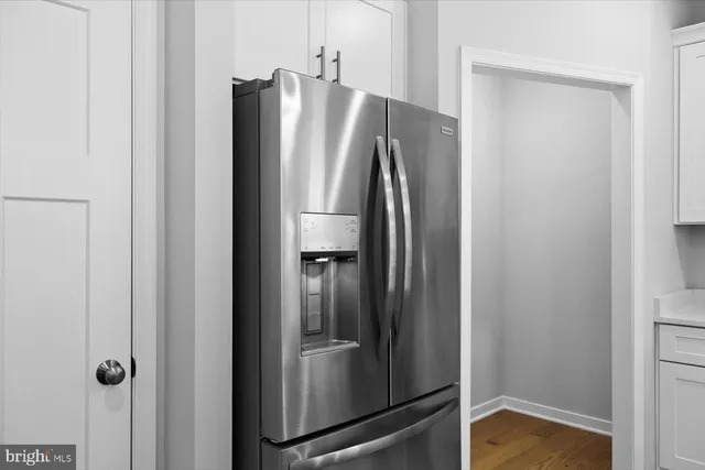 a metallic refrigerator freezer sitting in a kitchen