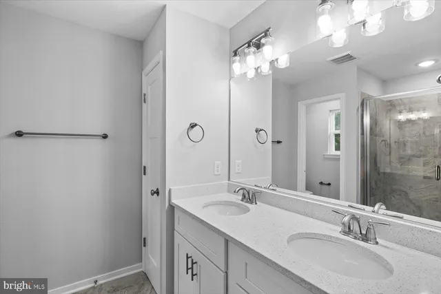 a bathroom with a glass shower door