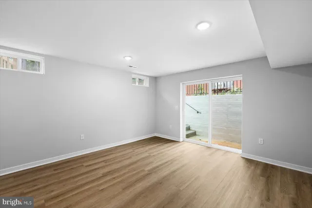 a view of empty room with wooden floor