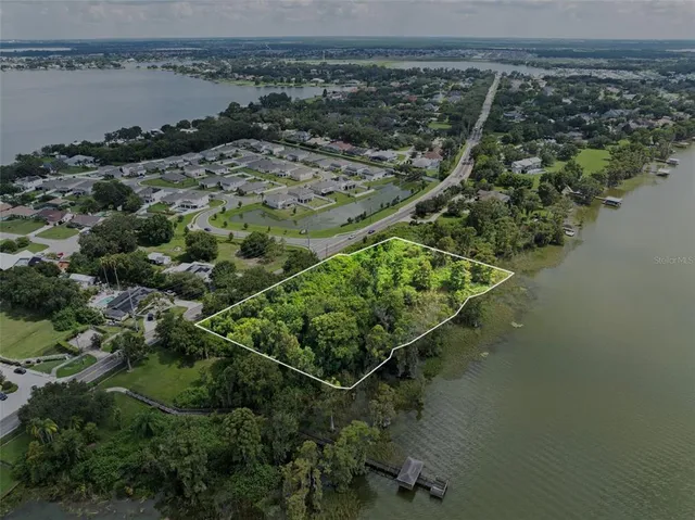 view of a lake with a forest