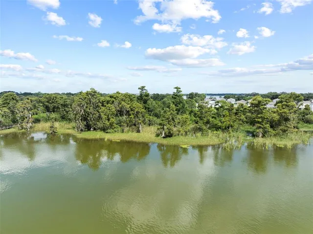 a view of a lake with houses in the back