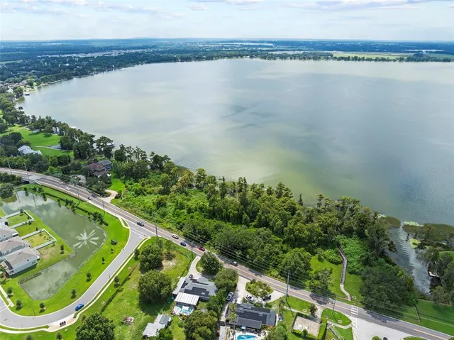 a view of a lake with a wooden bridge