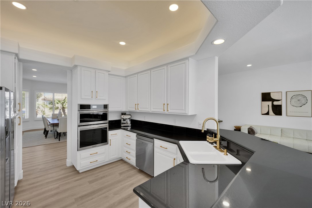8981 Rivers Edge Drive Las Vegas, NV 89117 - Photo 19 of 69 A gourmet kitchen boasts gleaming countertops and integrated appliances, perfect for entertaining.