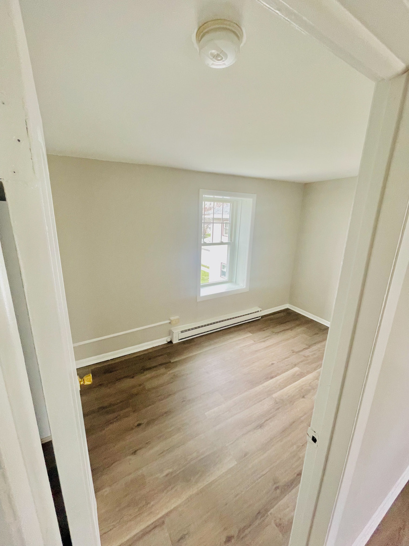 553 South 3rd Avenue Kankakee, IL 60901 - Photo 11 of 14 an empty room with wooden floor and windows