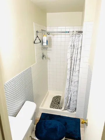 a view of bathroom with a shower and a sink