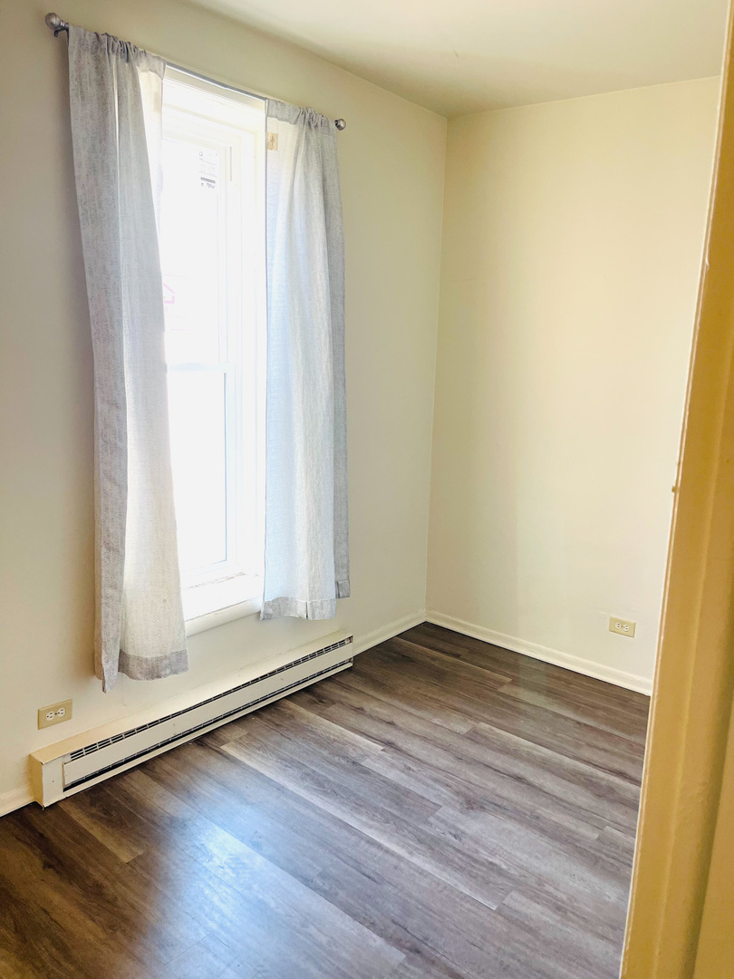 553 South 3rd Avenue Kankakee, IL 60901 - Photo 14 of 14 a view of an empty room with wooden floor and a window