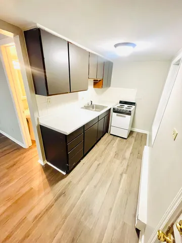 a spacious bathroom with a tub sink and mirror