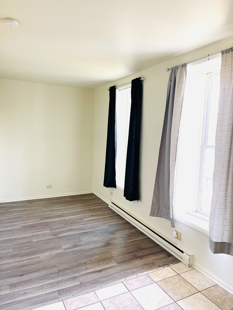 553 South 3rd Avenue Kankakee, IL 60901 - Photo 8 of 14 a view of an empty room with wooden floor and a window