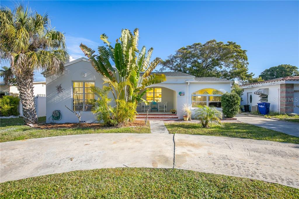15825 1st Street East Redington Beach, FL 33708 - Photo 1 of 1 a front view of house with yard and green space