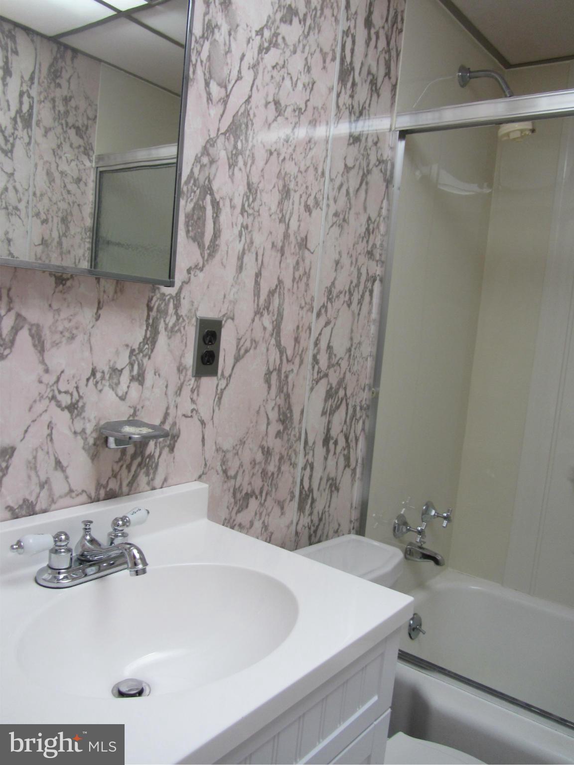 8655 Oak Road Baltimore, MD 21234 - Photo 14 of 27 a bathroom with a sink and a bathtub