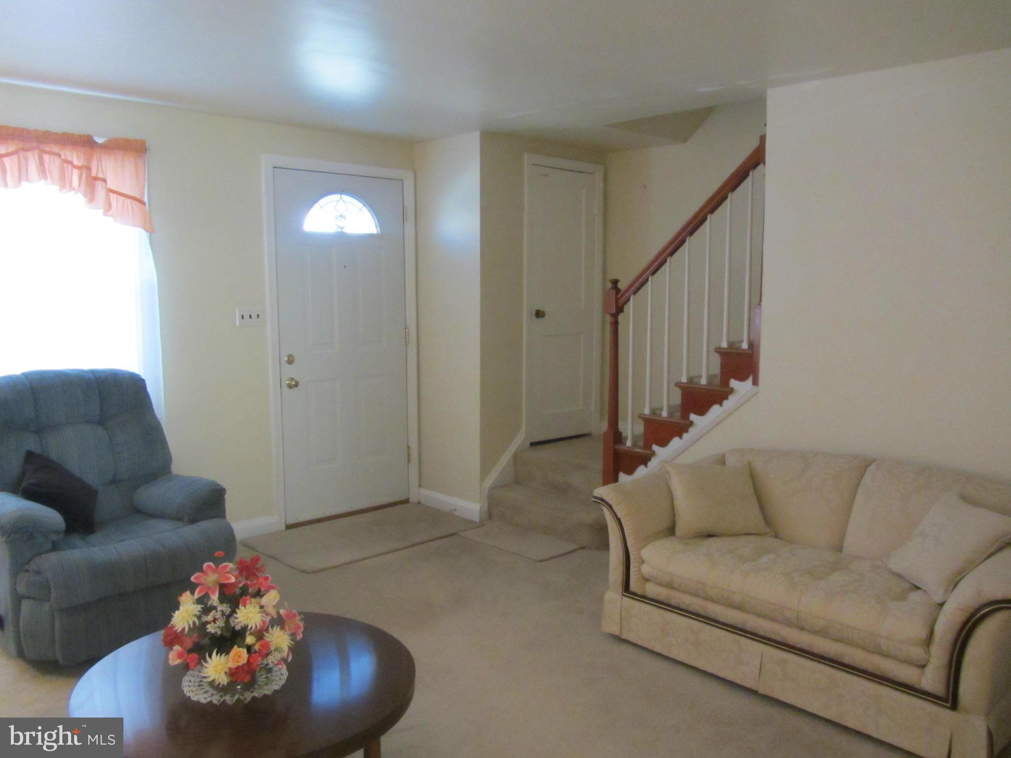 8655 Oak Road Baltimore, MD 21234 - Photo 3 of 27 a living room with furniture and a potted plant
