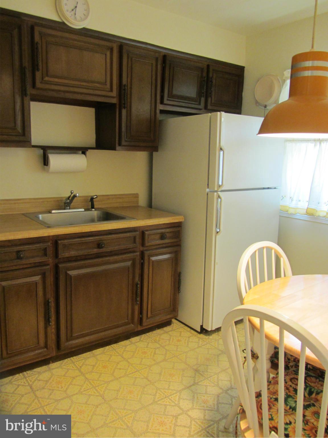 8655 Oak Road Baltimore, MD 21234 - Photo 4 of 27 a kitchen with a sink a stove and a refrigerator