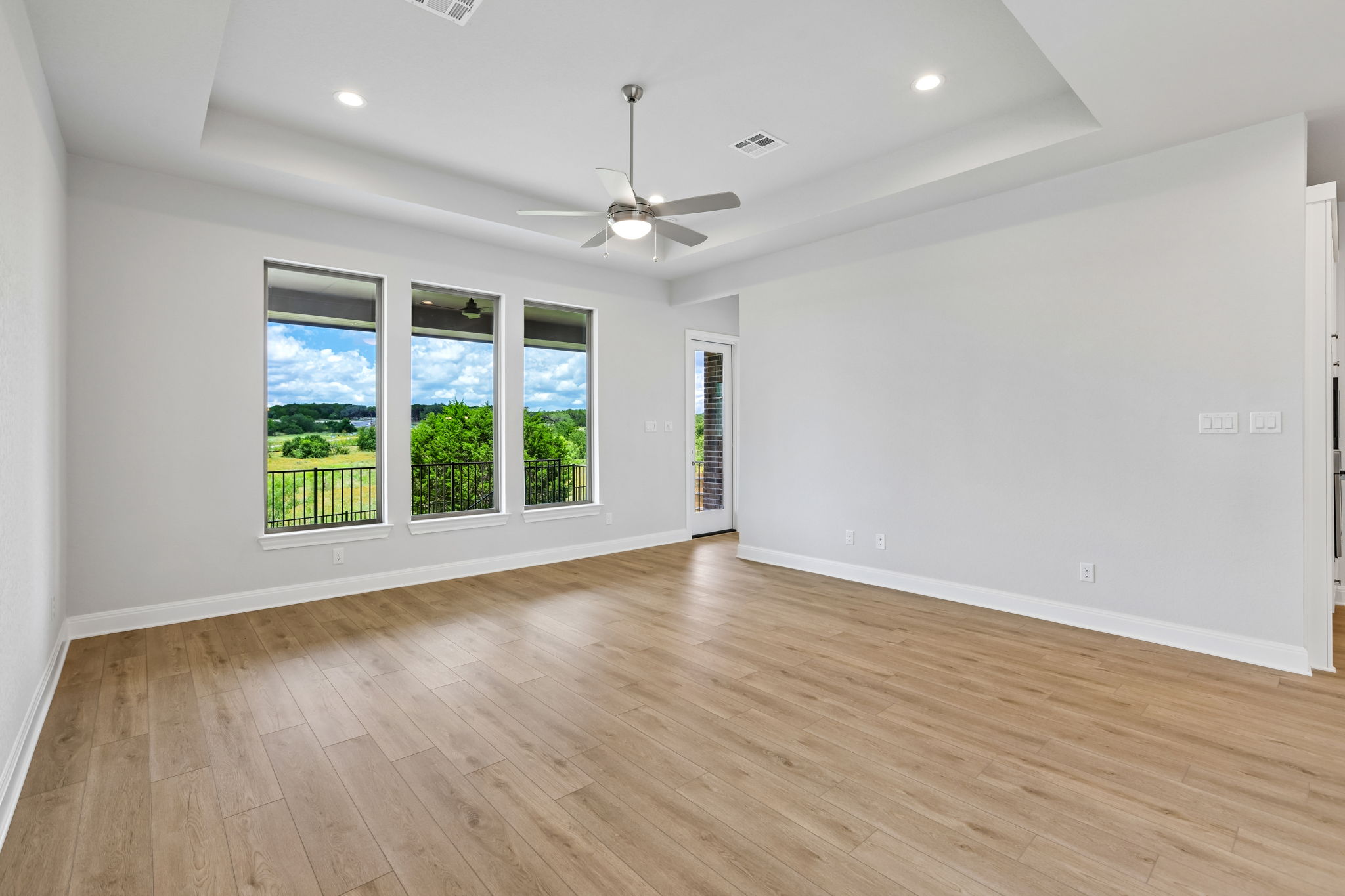 214 Prickly Poppy Loop Kyle, TX 78640 - Photo 8 of 38 an empty room with wooden floor and windows
