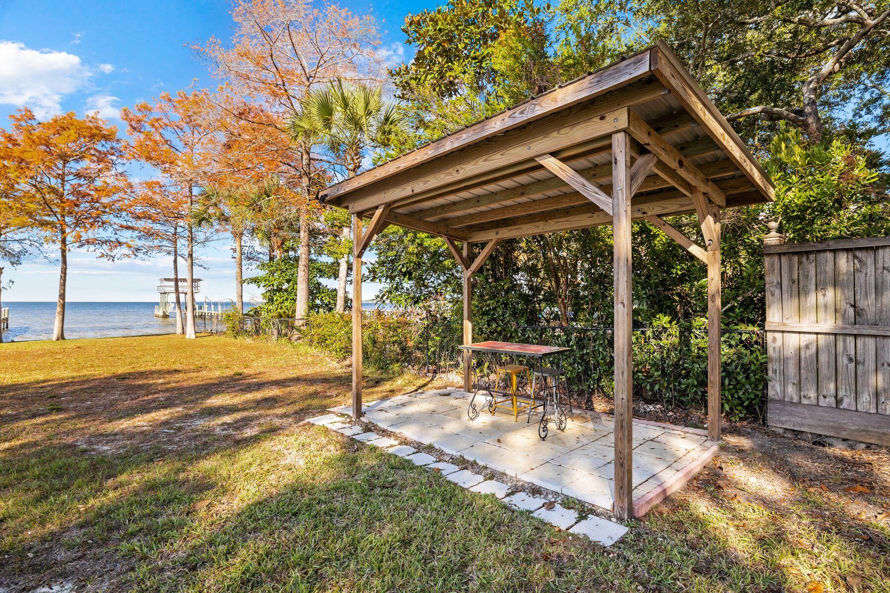 2452 Bay Grove Road Freeport, FL 32439 - Photo 44 of 51 a patio with a yard table and chairs