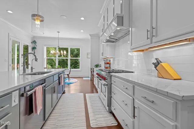 a kitchen with stainless steel appliances granite countertop a sink and cabinets