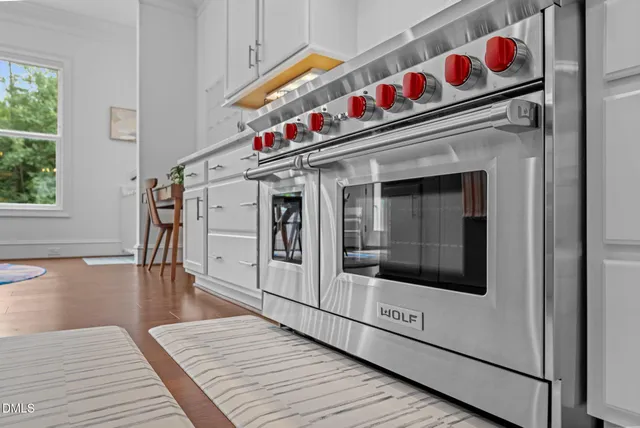 a bedroom with a bed and a flat tv screen on dresser