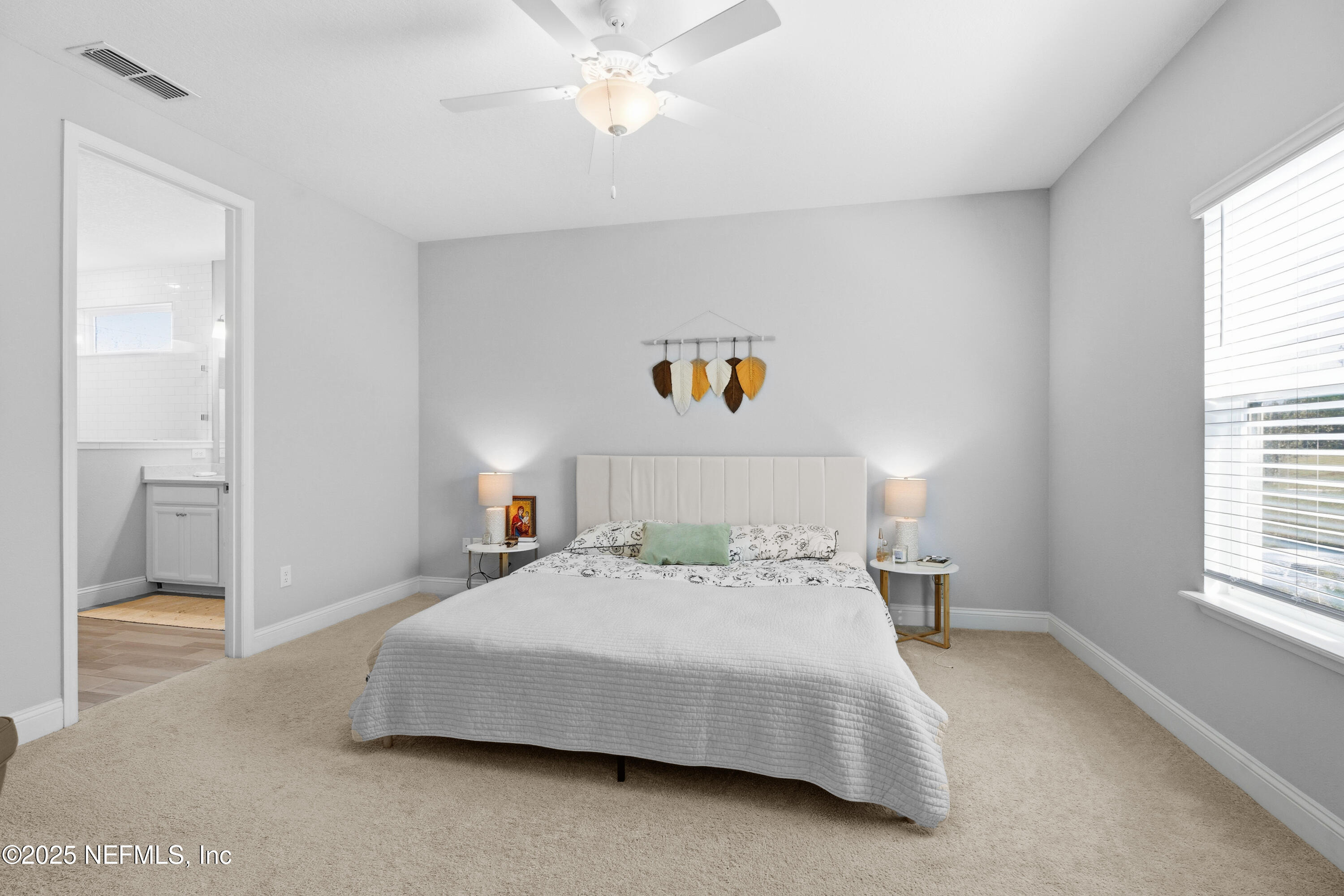 165 Killarney Avenue St. Johns, FL 32259 - Photo 16 of 63 a bedroom with a large bed and a chandelier