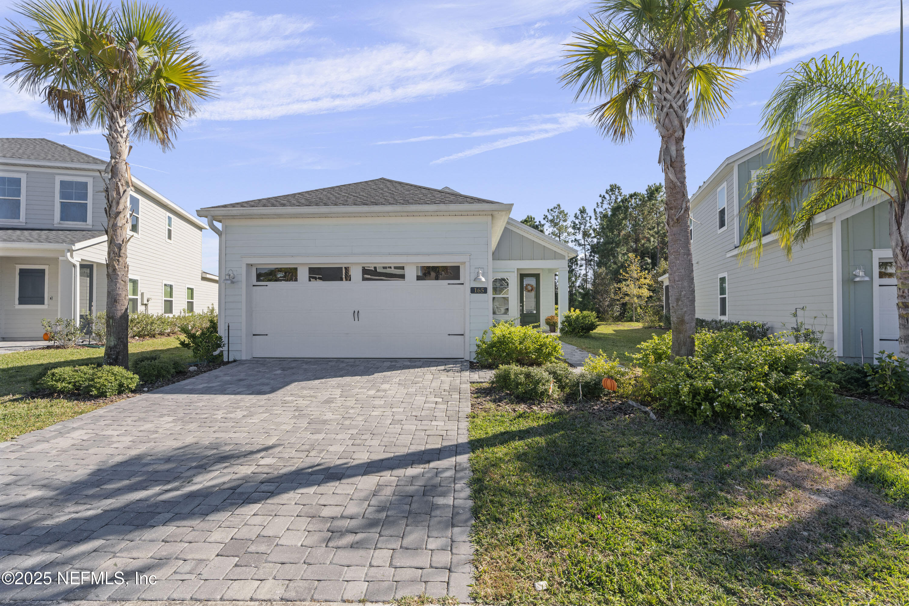 165 Killarney Avenue St. Johns, FL 32259 - Photo 2 of 63 a front view of a house with a garden