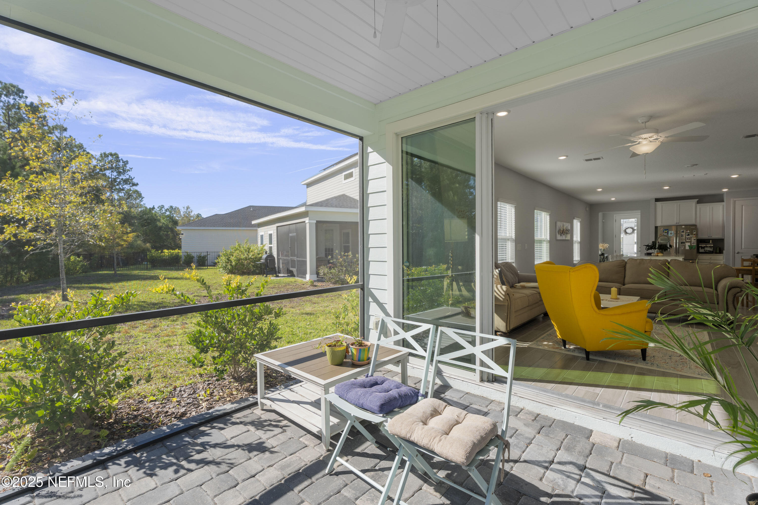 165 Killarney Avenue St. Johns, FL 32259 - Photo 29 of 63 a view of a patio with couches chairs and floor to ceiling window with yard