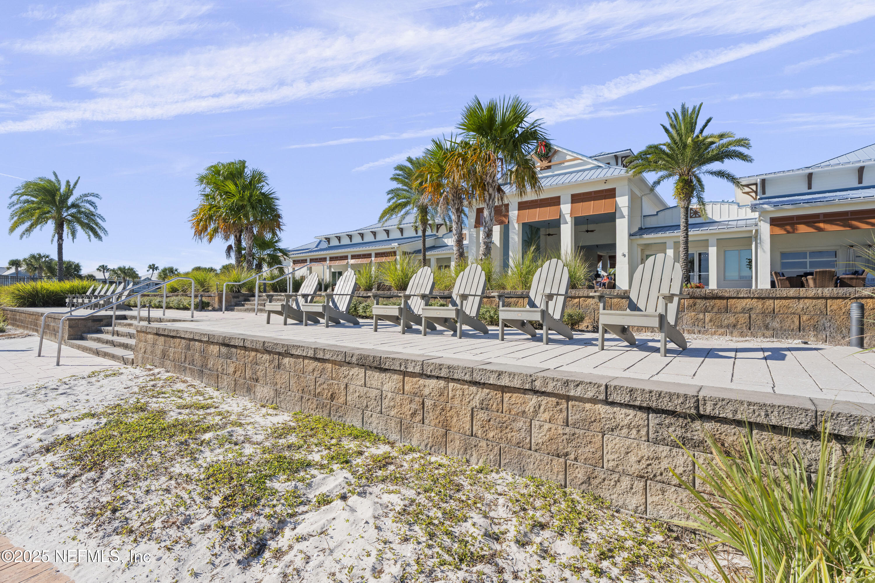165 Killarney Avenue St. Johns, FL 32259 - Photo 52 of 63 a view of a swimming pool with a lawn chairs under palm trees