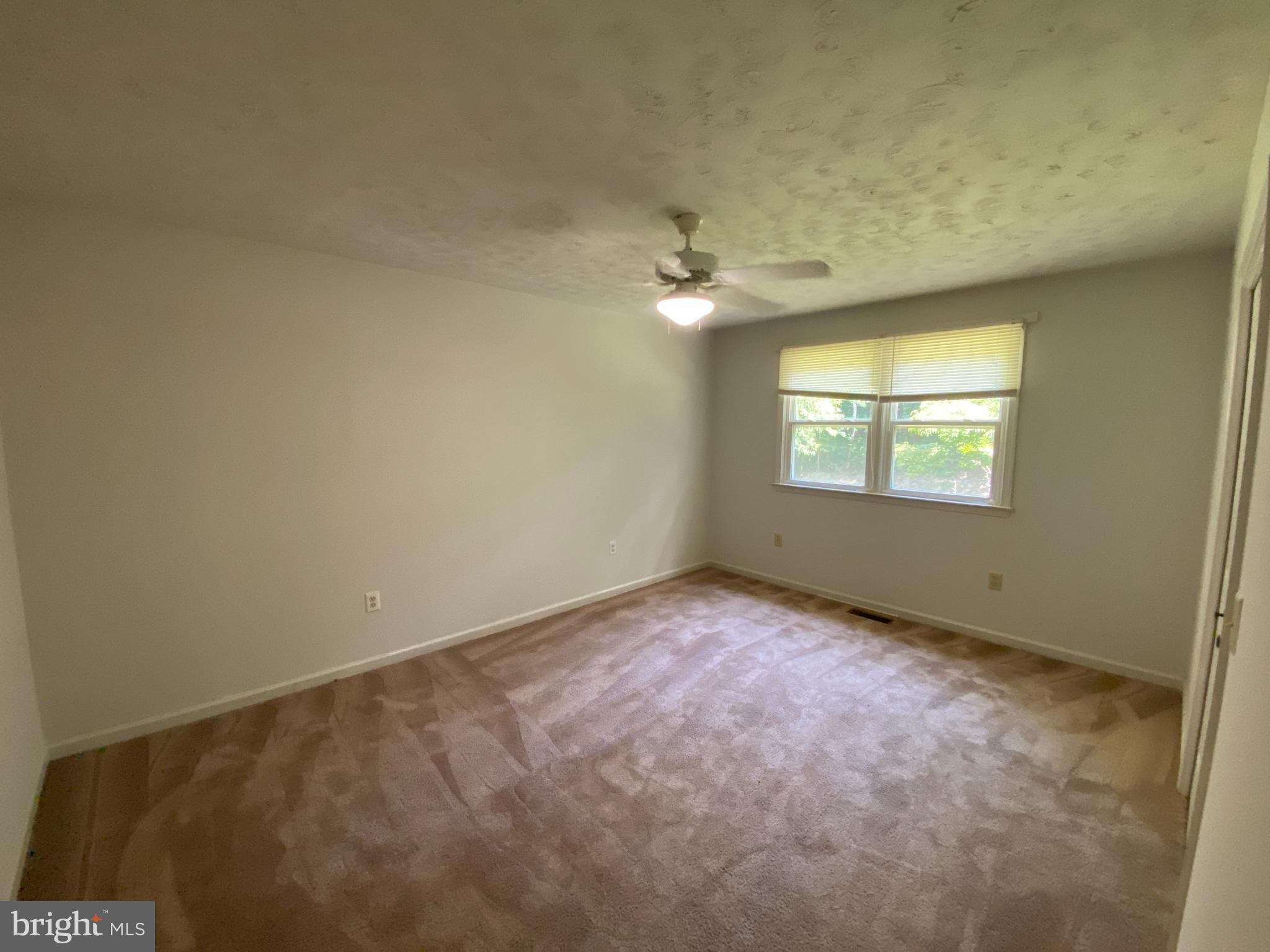8444 Indiantown Road King George, VA 22485 - Photo 14 of 22 an empty room with windows and fan