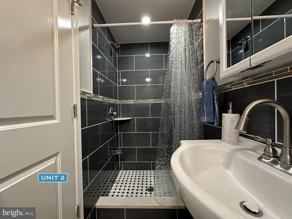 1606 Point Breeze Avenue Philadelphia, PA 19145 - Photo 19 of 35 a bathroom with a sink and a shower