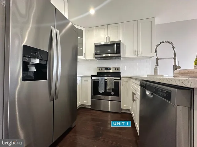 a kitchen with stainless steel appliances a refrigerator stove and microwave